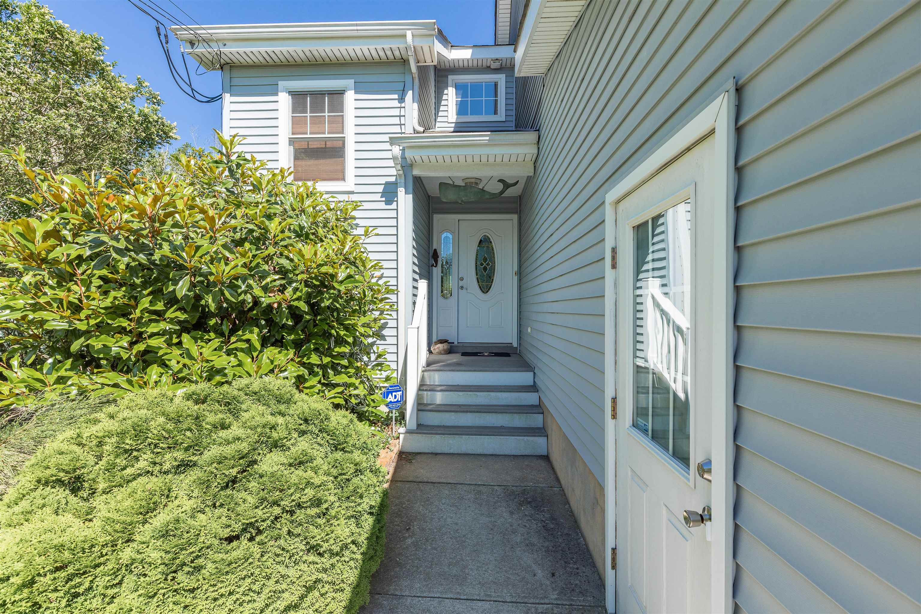 3125 Shunpike Road, Unit A Rio Grande, NJ 08242 - Photo 3 of 41 a view of a pathway of a house with potted plants