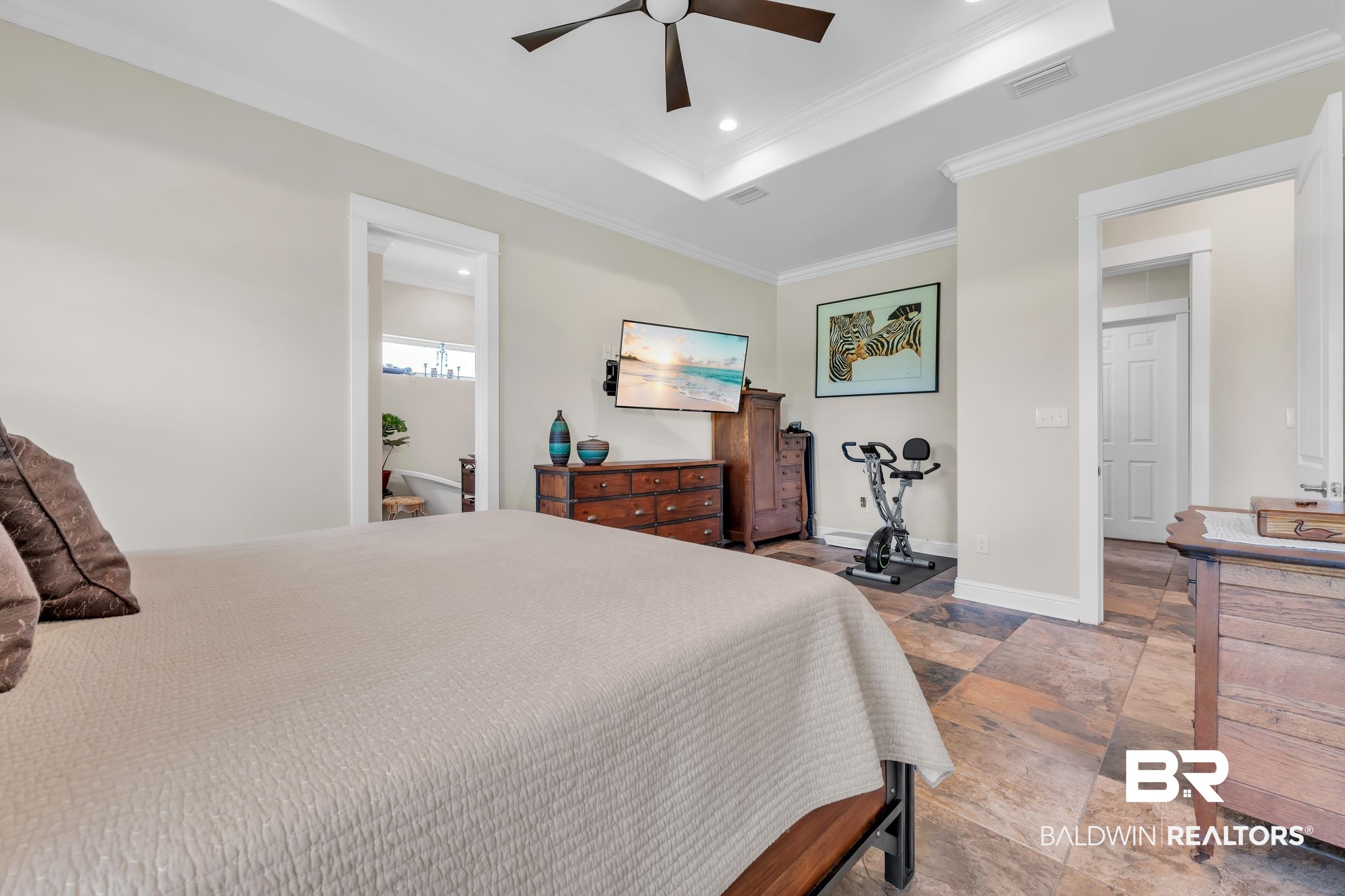 28918 Comstock Road Elberta, AL 36530 - Photo 33 of 53 Bedroom with crown molding, a tray ceiling, recessed lighting, stone finish floors, and ceiling fan