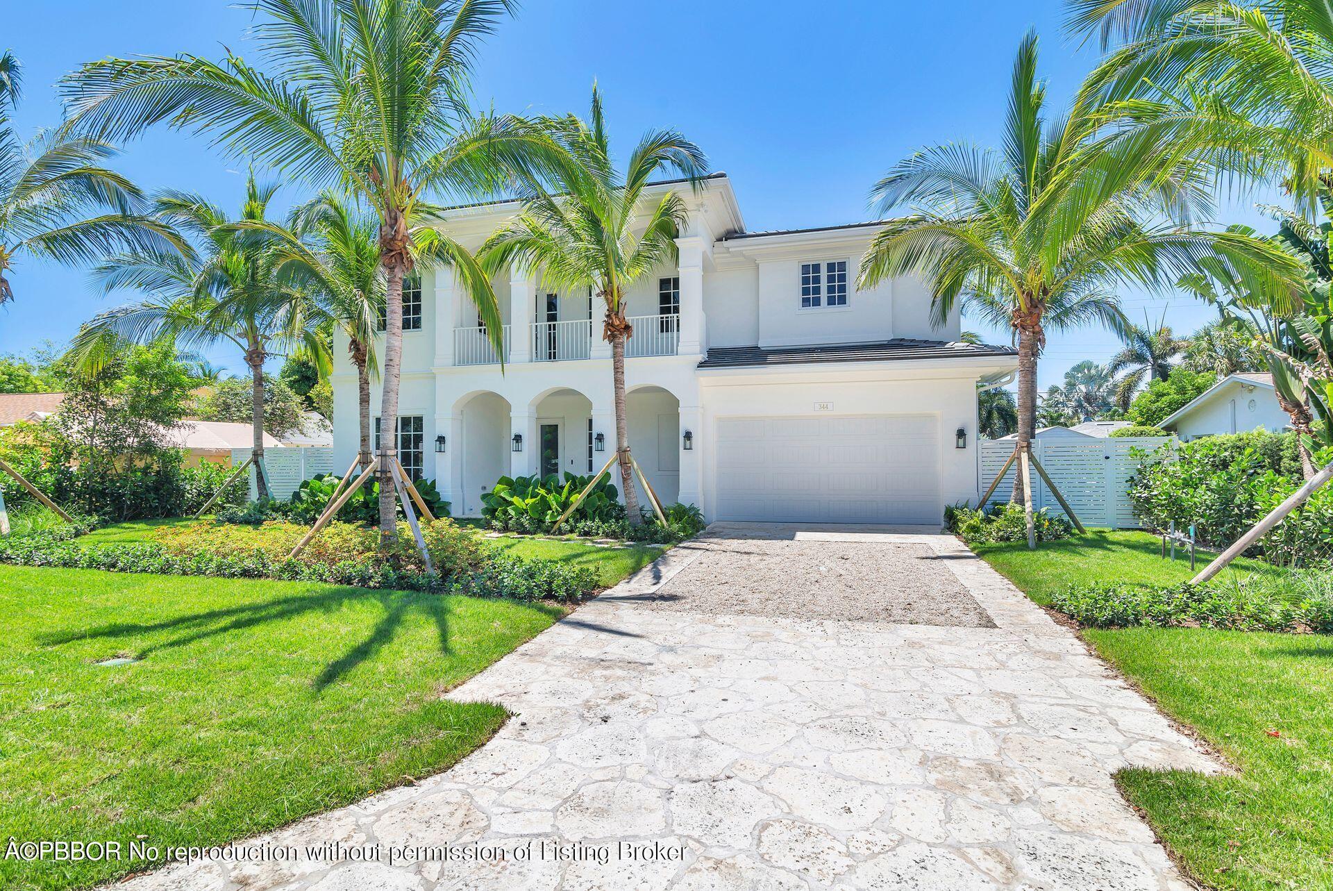 344 Churchill Road West Palm Beach, FL 33405 - Photo 40 of 41 a front view of yellow house with a yard and potted plants
