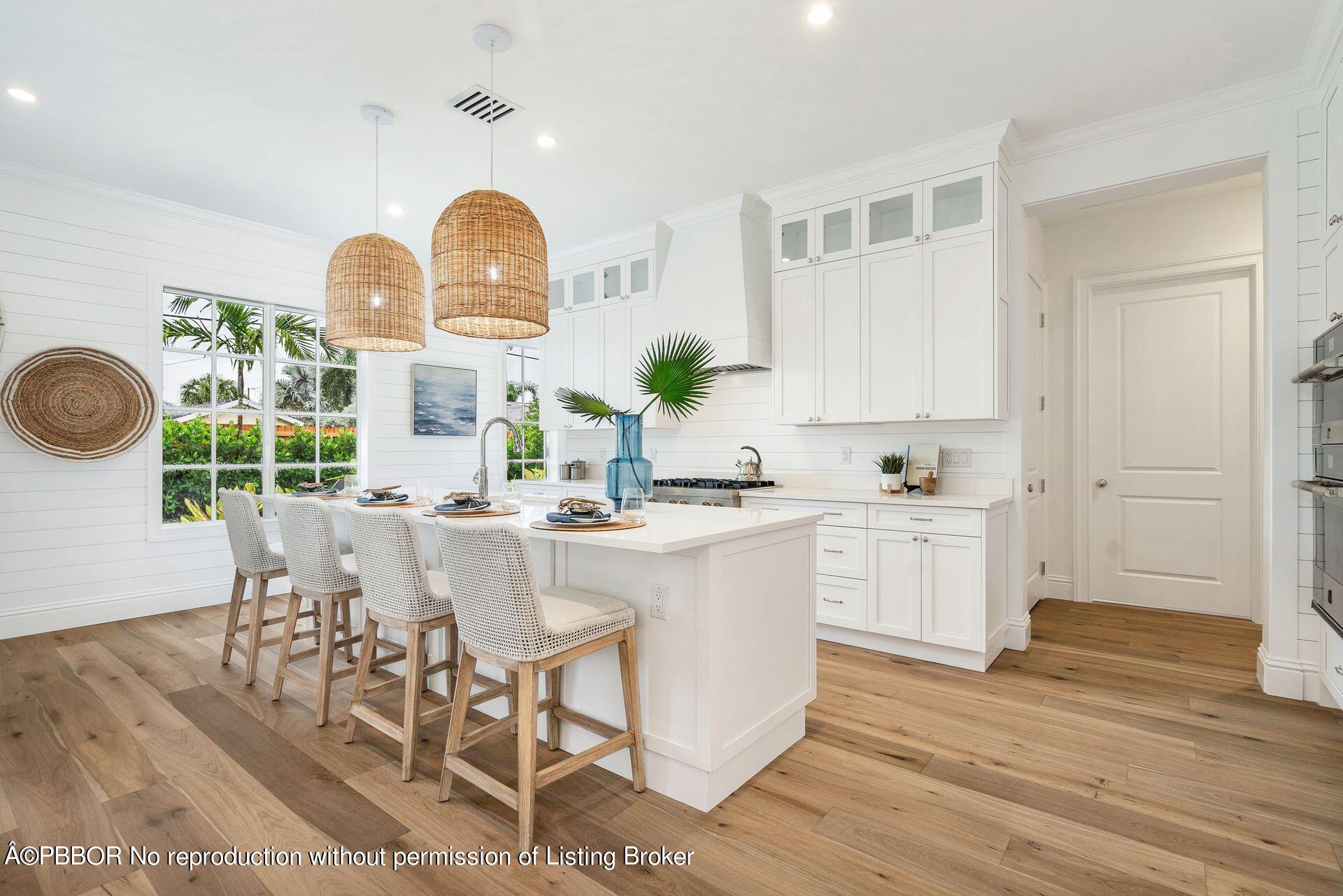344 Churchill Road West Palm Beach, FL 33405 - Photo 8 of 41 a kitchen with stainless steel appliances a dining table chairs and wooden floor