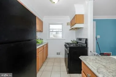 a kitchen with a stove top oven and refrigerator