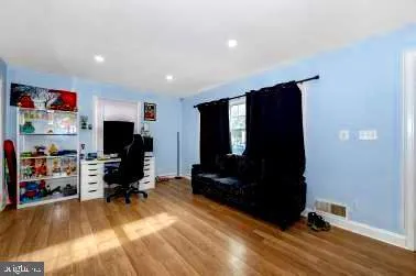 a living room with a flat screen tv and gym equipment