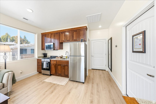 357 East Main Street Enterprise, UT 84725 - Photo 71 of 71 Kitchen featuring stainless steel appliances, light wood finished floors, light stone counters, recessed lighting, and open floor plan