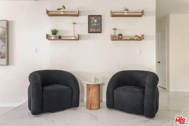 a living room with furniture and a chair