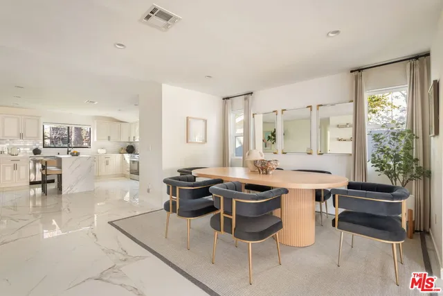 a room with a table chairs and a stove