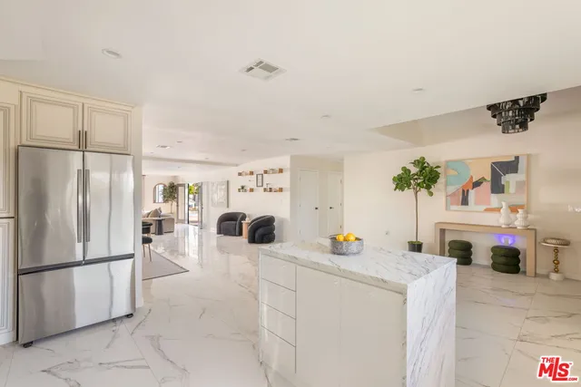 a bedroom with a large bed a flat screen tv and a couch