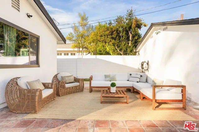 a view of a swimming pool with a patio and a yard
