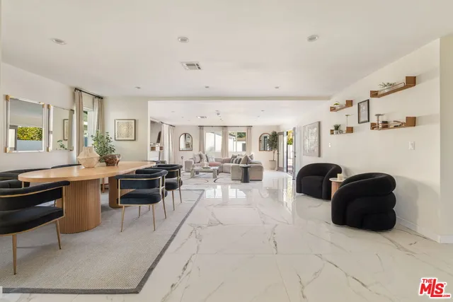 a living room with furniture a rug and a window