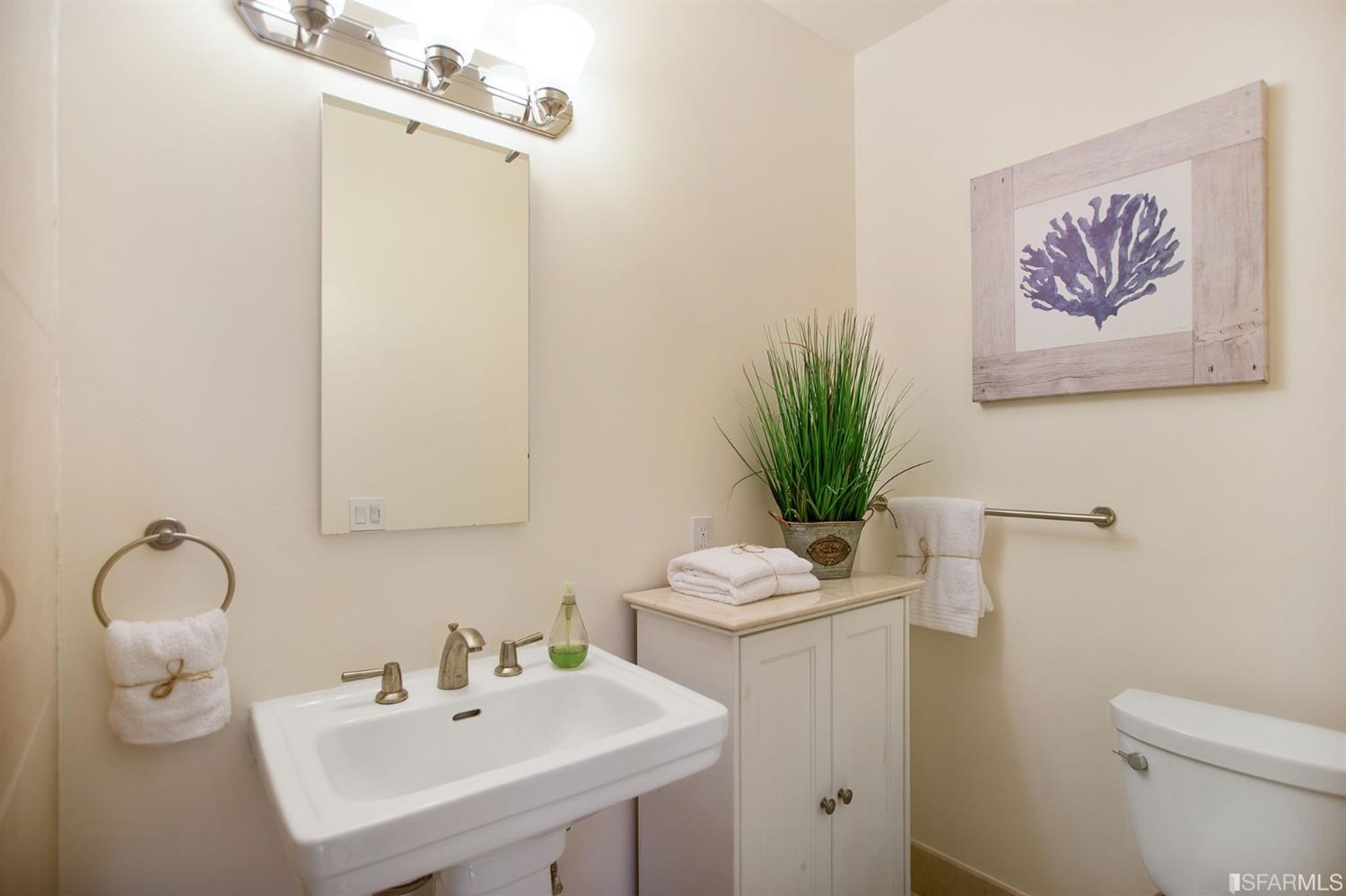 2387 Cedar Street Berkeley, CA 94708 - Photo 11 of 76 a bathroom with a sink a toilet and mirror