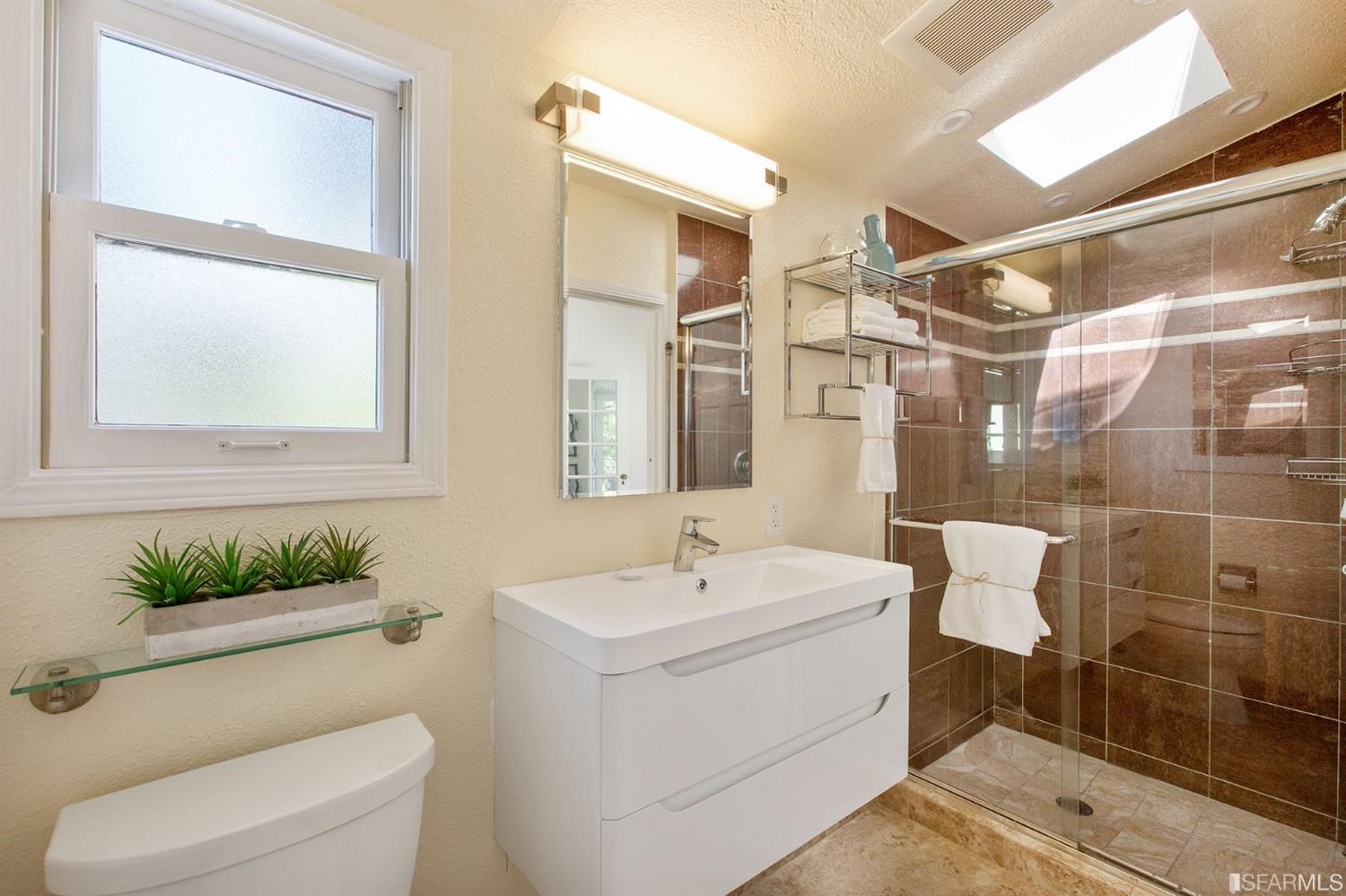 2387 Cedar Street Berkeley, CA 94708 - Photo 14 of 76 a bathroom with a sink and mirror with toilet