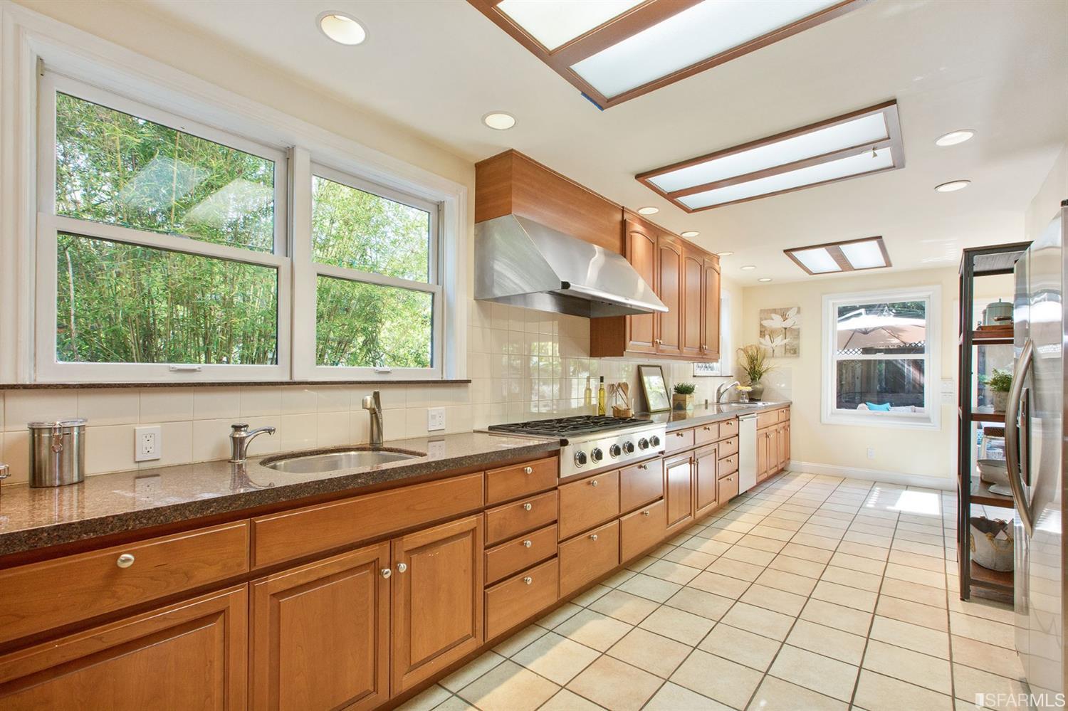 2387 Cedar Street Berkeley, CA 94708 - Photo 46 of 76 a large kitchen with stainless steel appliances granite countertop a sink and cabinets