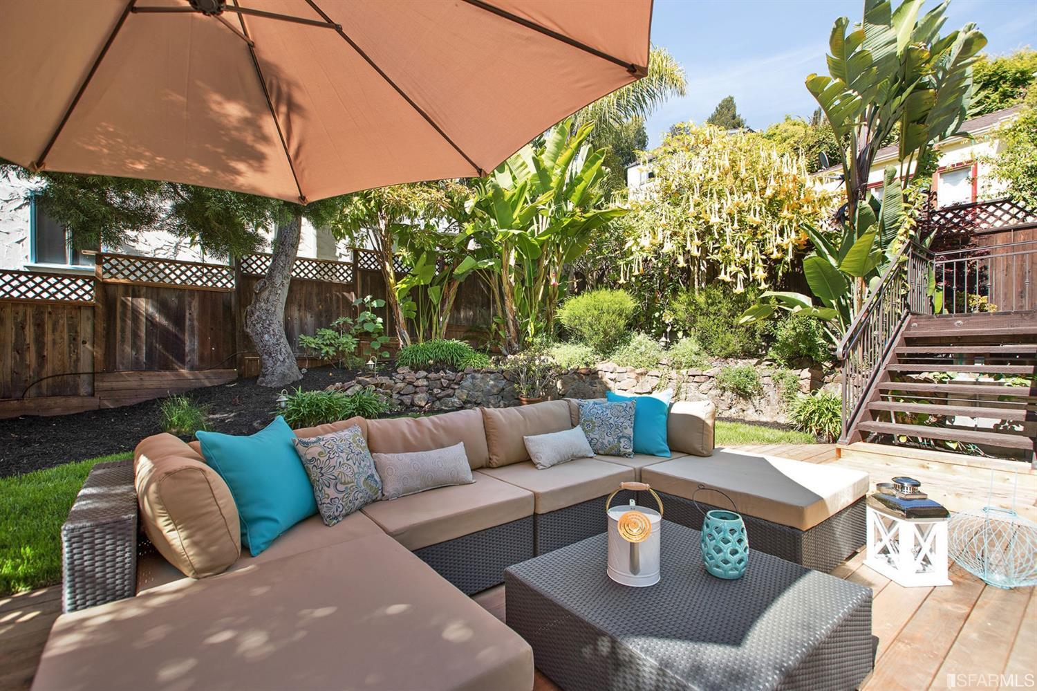2387 Cedar Street Berkeley, CA 94708 - Photo 61 of 76 a view of a patio with couches table and chairs under an umbrella