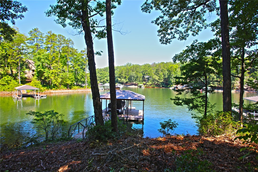 1359 Hbr Rdg Road Seneca, SC 29672 - Photo 30 of 39 Boathouses dot the serene lake, nestled amongst lush, verdant trees.