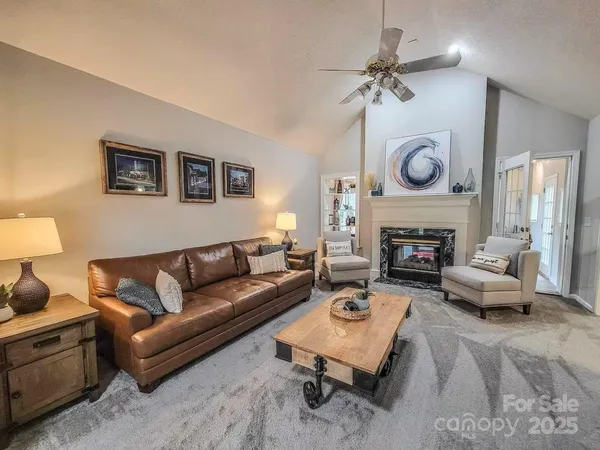 a living room with furniture and a fireplace