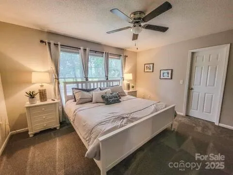a bed sitting in a spacious bedroom next to a window