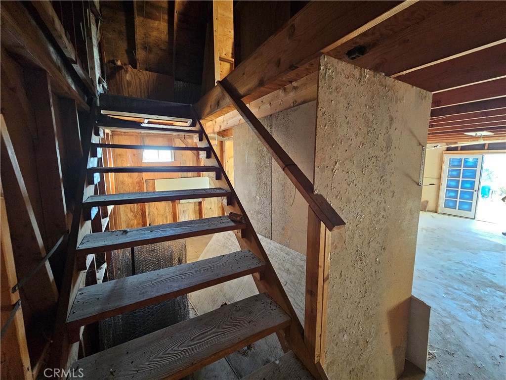 59600 Burnt Valley Road Anza, CA 92539 - Photo 12 of 22 a view of staircase with wooden floor and a window
