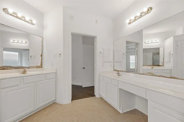 a spacious bathroom with a granite countertop sink mirror and double