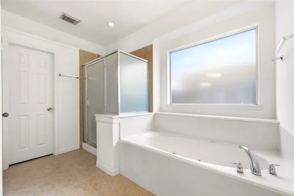 a bathroom with a bathtub and a sink