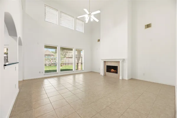 a view of an empty room with a fireplace and a window