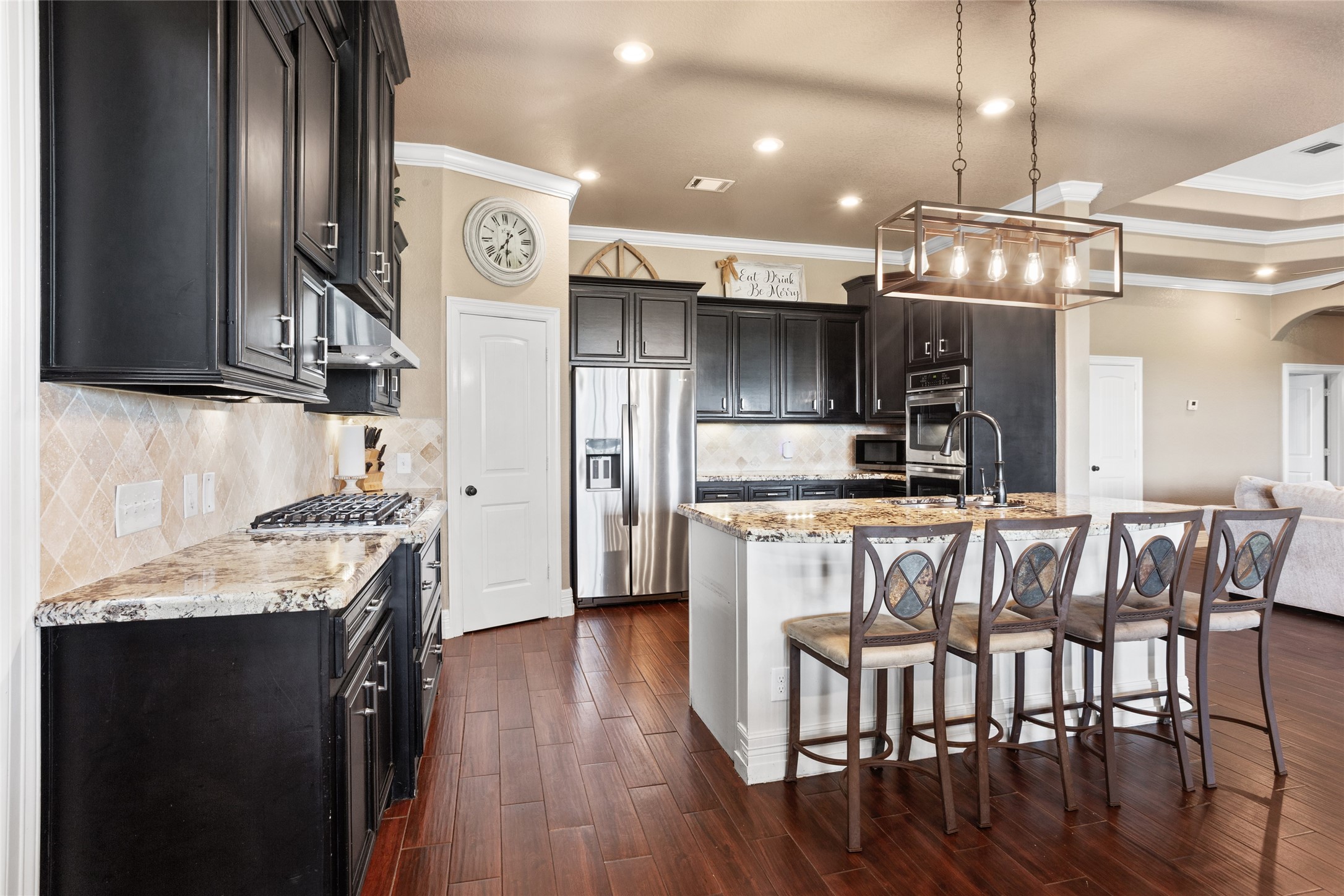 7842 Pebble Hill Lane Rosharon, TX 77583 - Photo 11 of 33 a kitchen with stainless steel appliances granite countertop a kitchen island hardwood floor and a sink