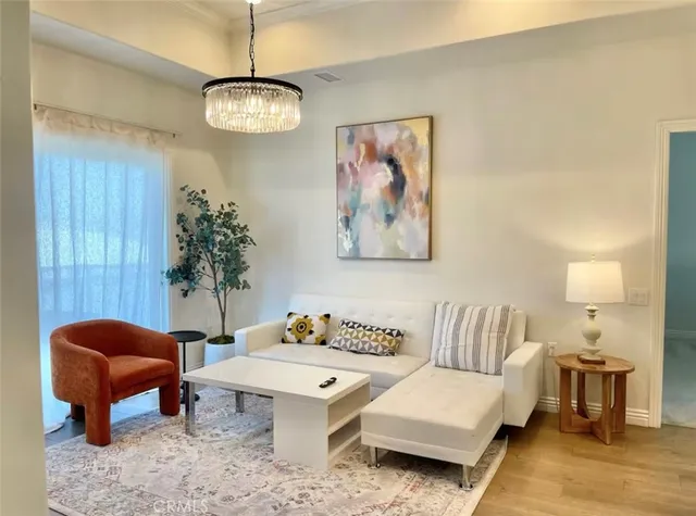 a living room with furniture and a potted plant