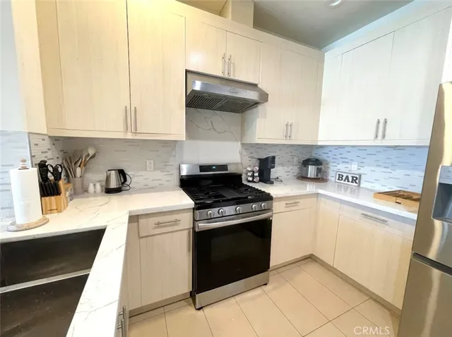 a kitchen with a stove top oven sink and cabinets