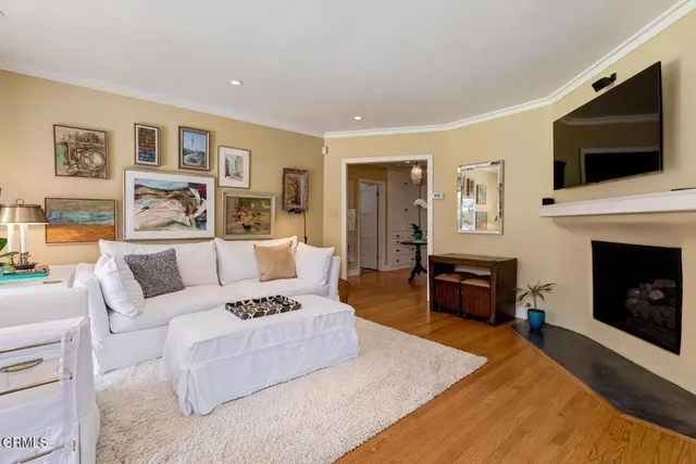 a living room with furniture fireplace and flat screen tv