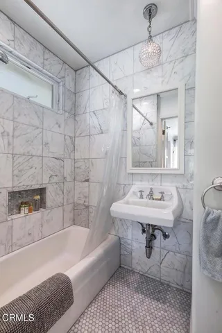 a bathroom with a sink a toilet and bathtub