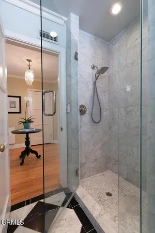 a bathroom with a glass shower door