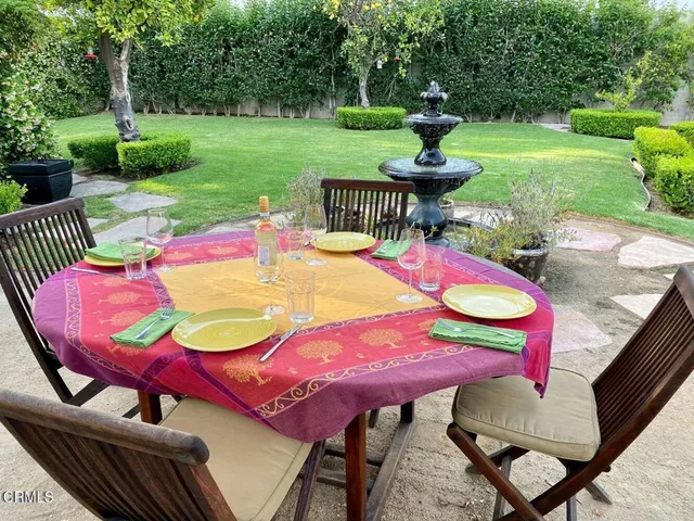 a view of a patio with table and chairs potted plants with wooden floor