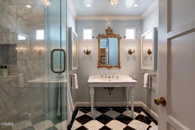 a bathroom with a sink a mirror and shower