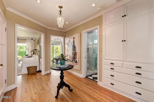 a view of a hallway with furniture and front door