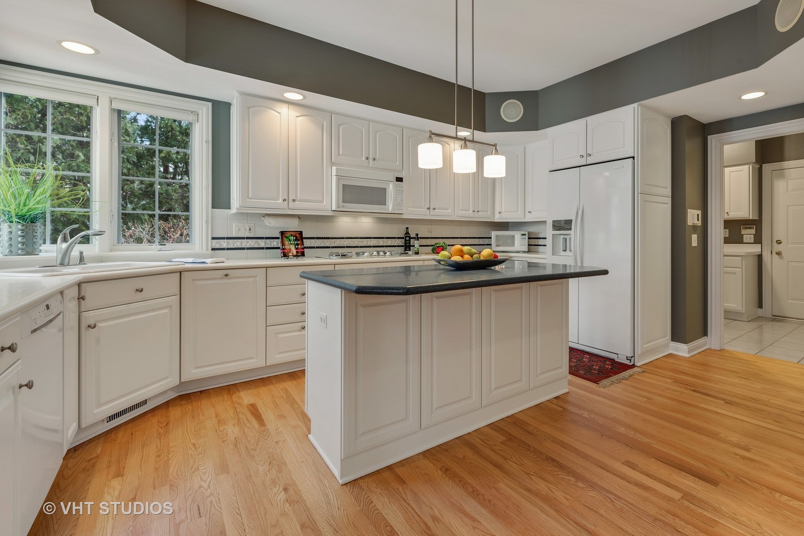 1426 Linden Road Northbrook, IL 60062 - Photo 11 of 27 a kitchen with a sink a window stainless steel appliances and cabinets