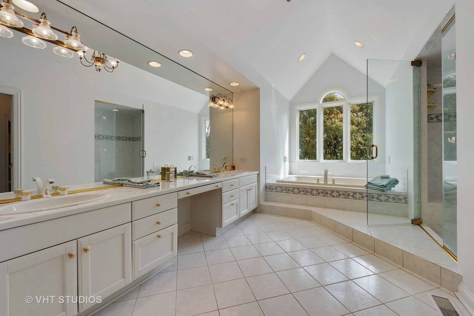 1426 Linden Road Northbrook, IL 60062 - Photo 17 of 27 a large white bathroom with a granite countertop sink mirror and bathtub