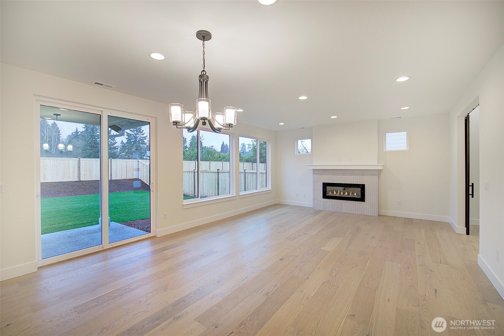 727 Covington Avenue Snohomish, WA 98290 - Photo 6 of 36 a view of an empty room with a fireplace and a chandelier