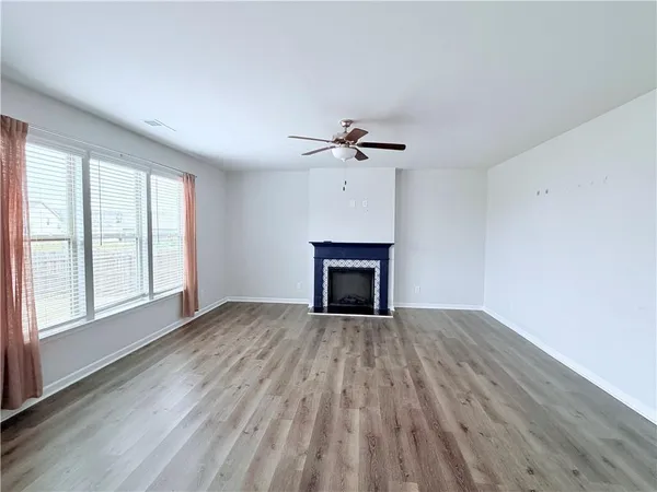 wooden floor fireplace and windows in a room