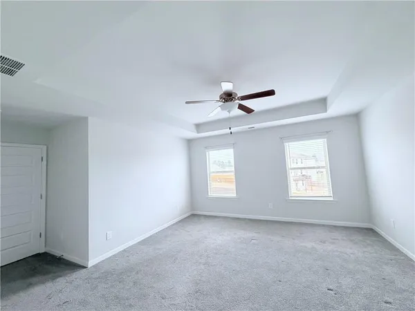 a view of room with window and ceiling fan