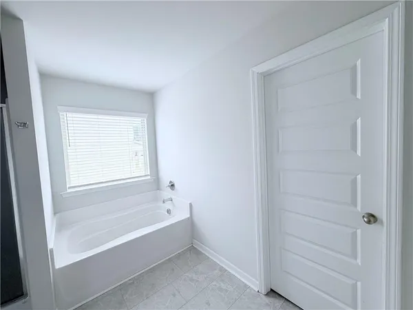 a bathroom with a bathtub and shower