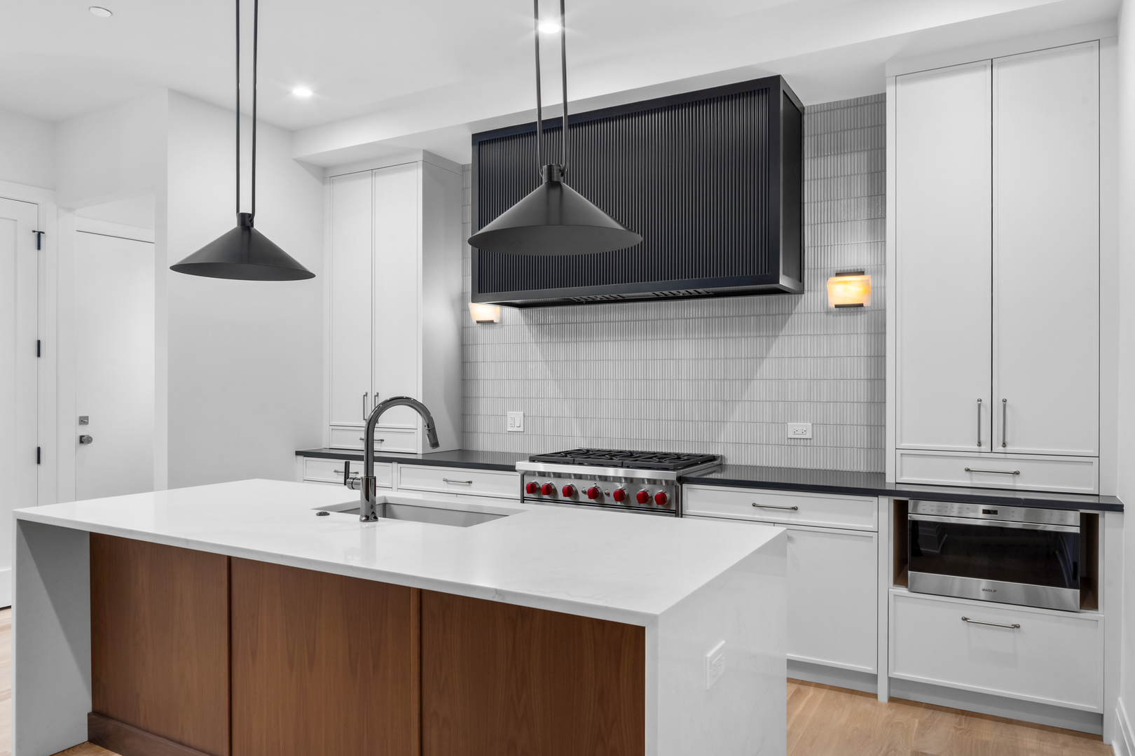 2832 North Racine Avenue, Unit 2W Chicago, IL 60657 - Photo 11 of 31 a kitchen with stainless steel appliances a sink a stove a microwave and cabinets