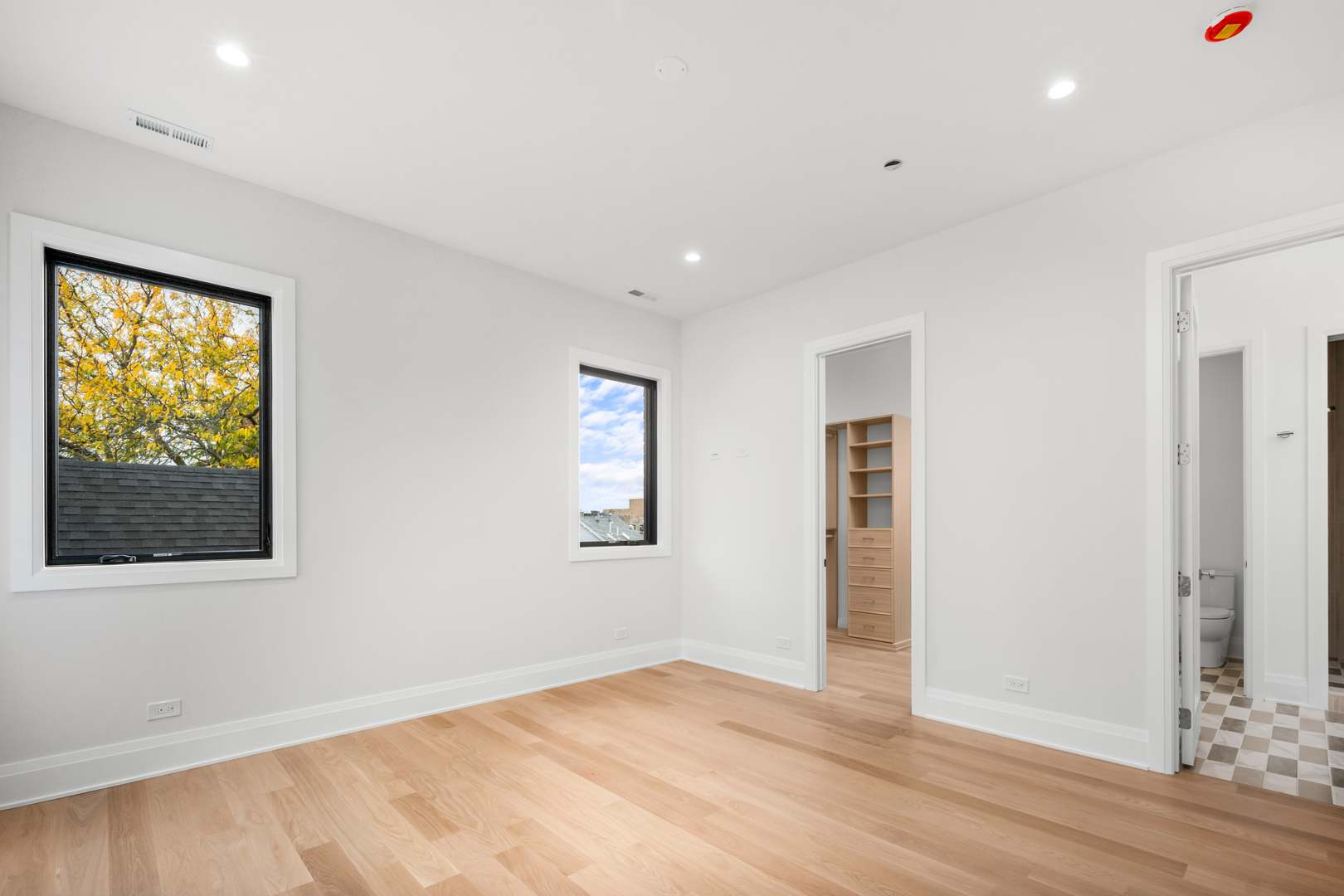 2832 North Racine Avenue, Unit 2W Chicago, IL 60657 - Photo 16 of 31 a view of an empty room with wooden floor and a window