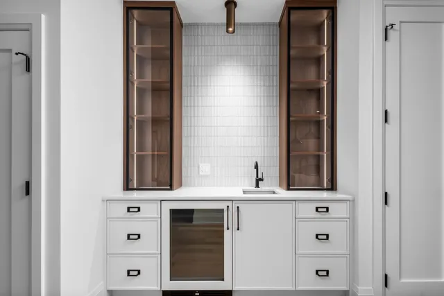 a kitchen with stainless steel appliances a sink and wooden floor