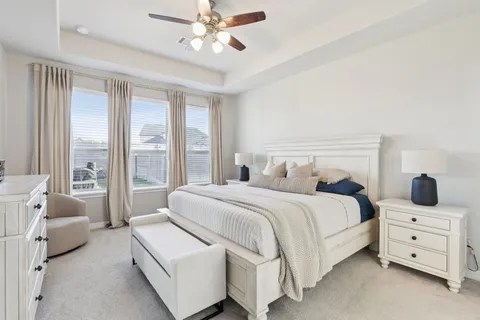 a bedroom with a large bed and a large window