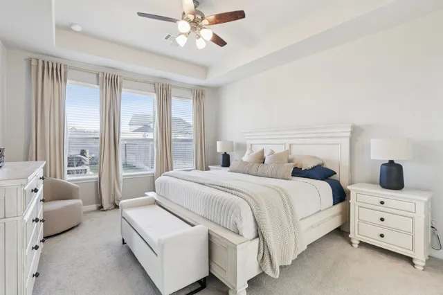 a bedroom with a large bed and a large window