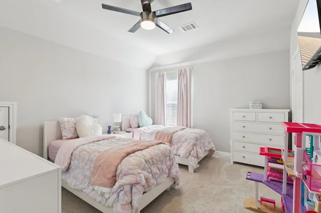 a bedroom with two beds and window
