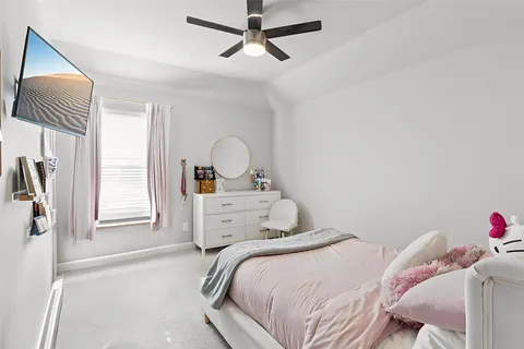 a bedroom with a bed and a dresser