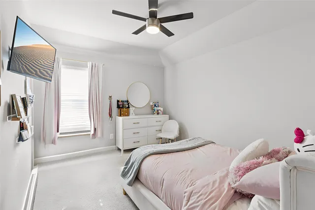 a bedroom with a bed and a dresser