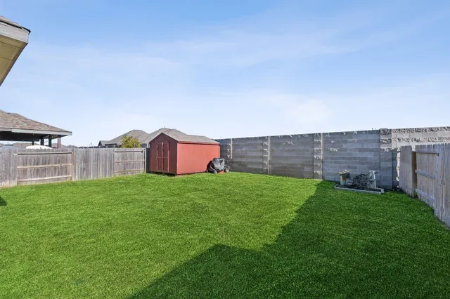 a view of a backyard with large trees