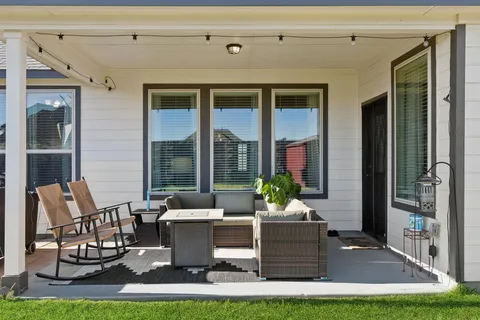 a front view of a house with outdoor seating