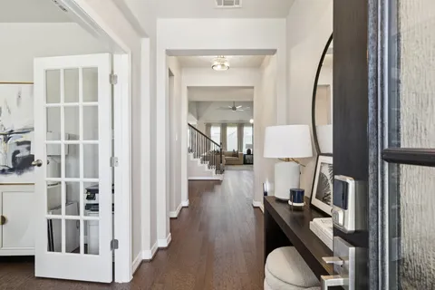 a view of a livingroom with furniture and hardwood floor