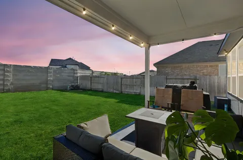 a view of a backyard with couches plants and a yard